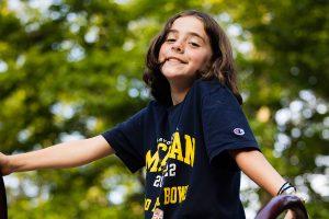 Boy plays on playground structure in nature