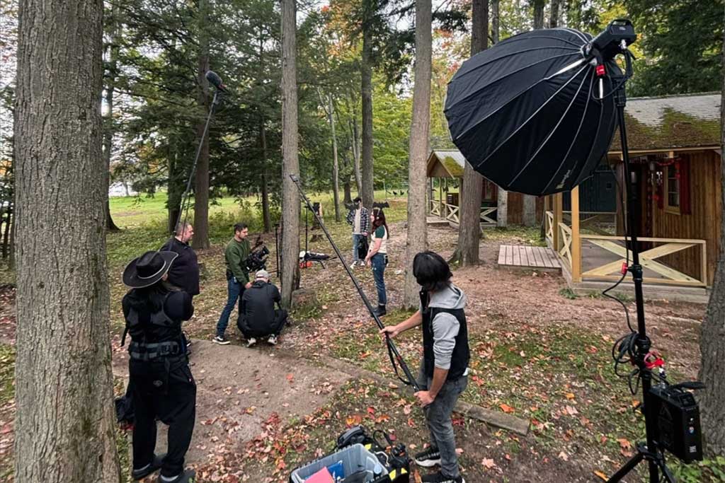 Film crew shooting a scene in the woods at Camp Walden
