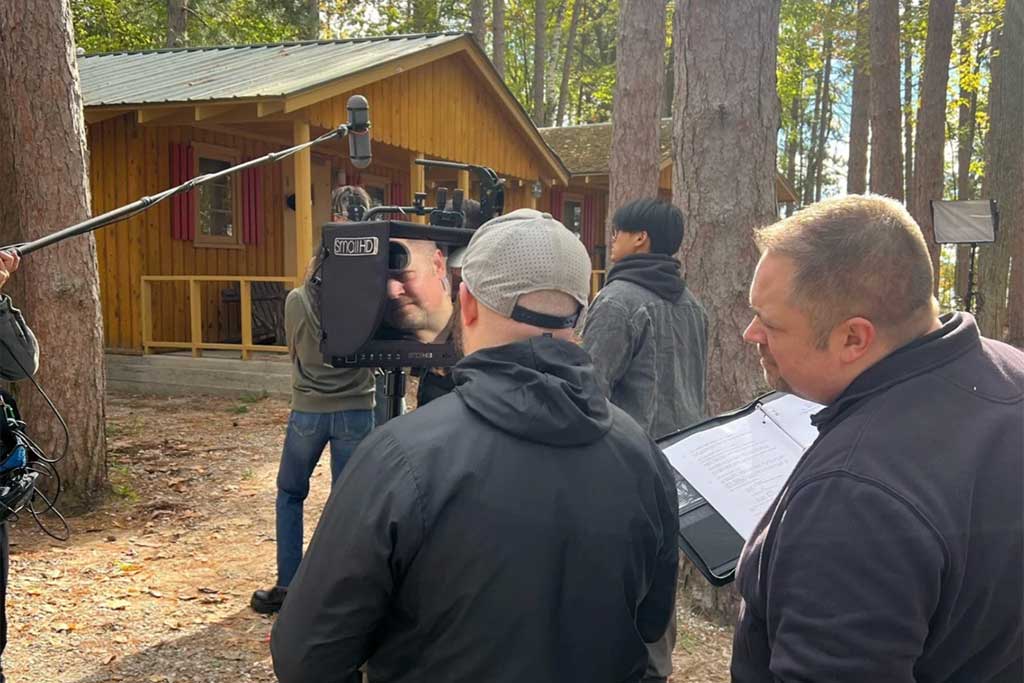 Director looks through viewfinder of camera